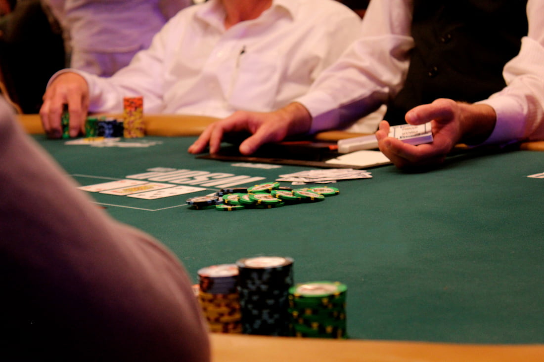 Dealer lays playing cards on the casino table.