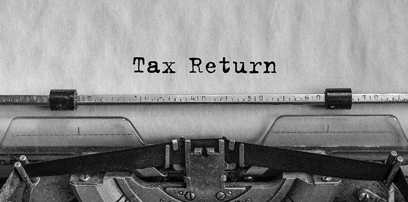 Typewriter With A Sheet Reading Tax Return